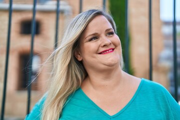 Young woman smiling confident looking to the side at street