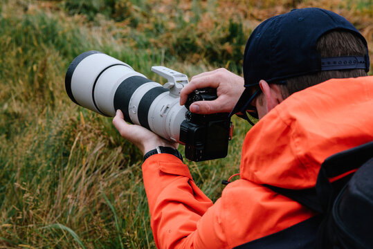 Fototapeta Wildlife Photographer with long zoom lens