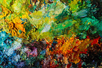 Fototapeta premium Background for artistic themes. The texture of the artist's palette close-up with yellow, green, blue and red colors