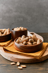 Image of bunch of peanuts in a bowl on a wooden table