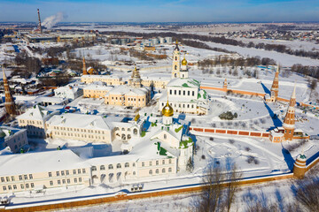 Aerial panoramic view of architectural complex of Epiphany Staro-Golutvin Monastery in ancient Russian city of Kolomna on sunny winter day..