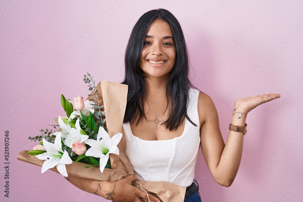 Sticker Brunette woman holding bouquet of white flowers pointing aside with hands open palms showing copy space, presenting advertisement smiling excited happy