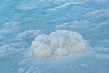 Texture of Dead sea coastline. Salt crystals at sunset, close up. Salty sea shore. Organic salt...