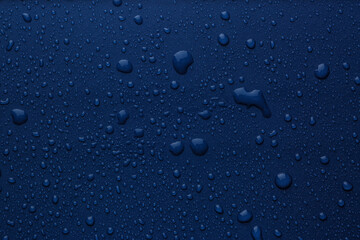 Many water drops on bright blue background