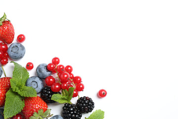 Mix of fresh berries on white background, flat lay