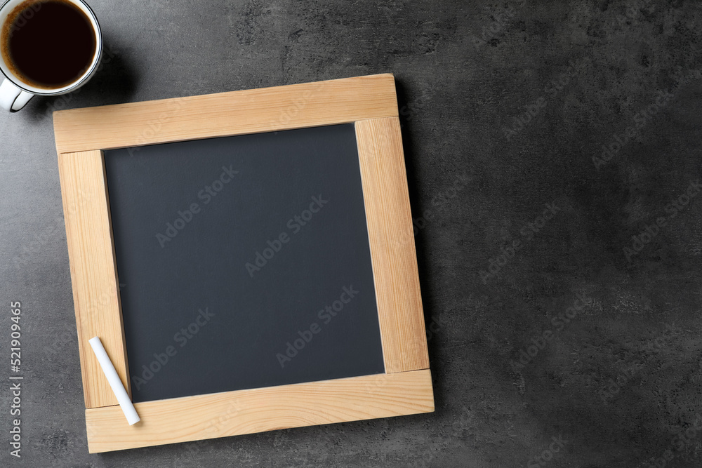 Sticker Clean small chalkboard and cup of coffee on grey table, flat lay. Space for text