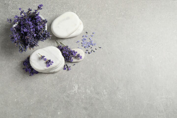 Stones, sea salt and lavender flowers on grey table, flat lay. Space for text