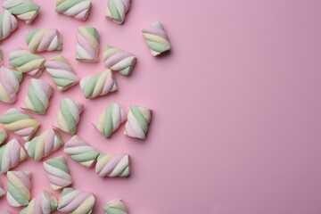 Delicious colorful marshmallows on pink background, flat lay. Space for text