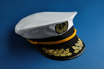 Peaked cap with accessories on blue background