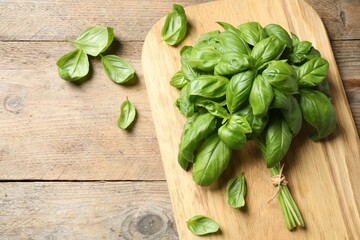 Fresh basil on wooden table, flat lay