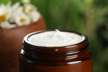 Jar of hand cream on blurred background, closeup