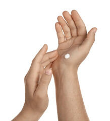 Man applying cream on hands against white background, closeup