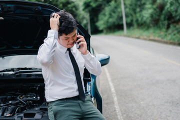 Asian businessman broken car engine breakdown his use mobile calling insurance smartphone problem, Accident emergency on the road concept.