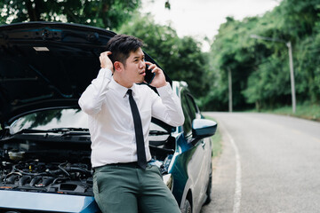 Asian businessman broken car engine breakdown his use mobile calling insurance smartphone problem, Accident emergency on the road concept.