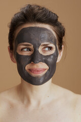 pensive modern woman with facial mask