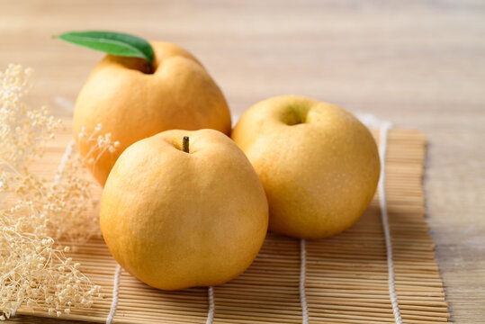 Asian pear or Nashi pear on wooden background