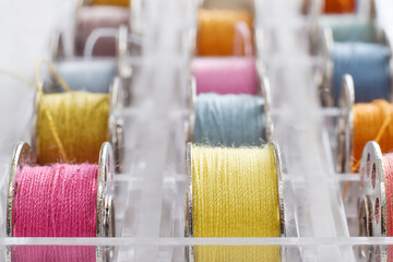Macro closeup colorful sewing thread bobbins