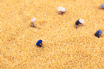 Fototapeta na wymiar Miniature scene straw hat farmer working