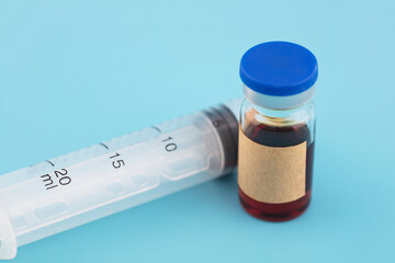 A bottle of medicine and a needle