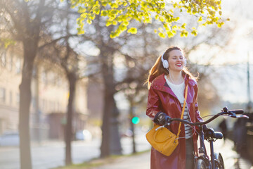 Fototapeta na wymiar smiling woman listening to music outdoors in city