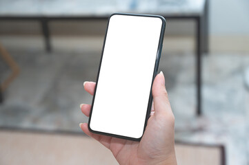 Close up women using a smartphone with an empty white screen at home.