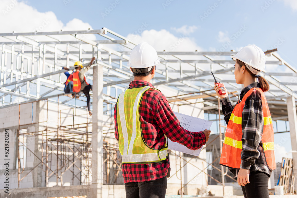 Poster back two architect and client discussing help create plan with blueprint home building at constructi