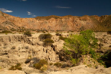 View of the arid desert, rocky cliffs and mountains, in a hot sunny day.