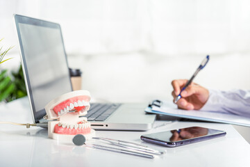 Oral dental. Dentist doctor in uniform writing information of patient in paperwork checklist on...