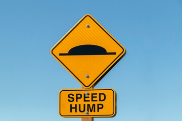 Speed hump ahead warning sign