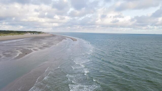 Aerial backwards shot over North Sea during ebb tide in Netherlands 