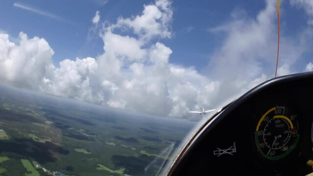 Glider with tow plane with beautiful cumulus clouds on a summer afternoon