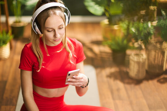 young woman in red fitness clothes at modern green home