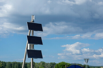 Solar panels on a pole against the blue sky. Renewable source of electrical energy. Green ecological energy.