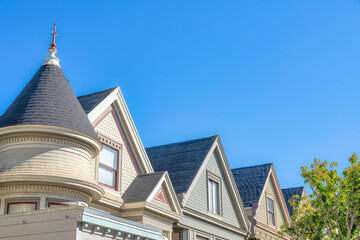 Row of queen anne houses with decorative shingles on its peak at San Francisco, California
