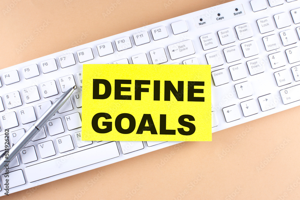 Poster text define goals text on a sticky on keyboard, business concept
