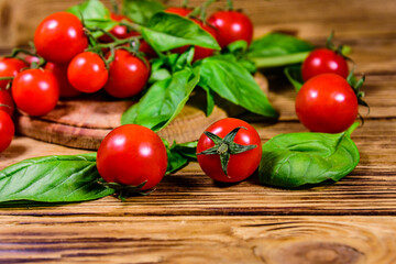 Heap of small cherry tomatoes on wooden table