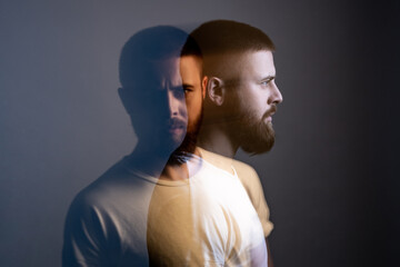 Fototapeta na wymiar Double exposure crative side view profile and portrait of artistic bearded model man in white t-shirt looking at camera with calm serious face. special blurred beauty effect. indoor studio shot.