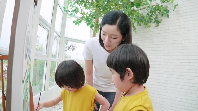 Colour Painting, Children drawing, and painting at home. Asian happy family performing activities together