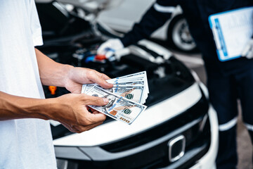 Customer pay with money for repair to the mechanic at garage workshop, Spending and car financial...