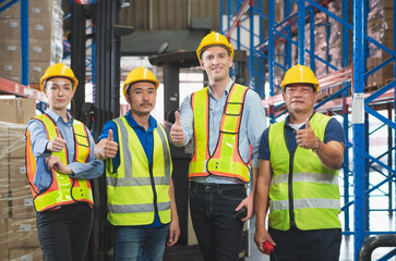 Success Teamwork Concepts, Foreman worker team smiling with showing thumbs up in a warehouse,...