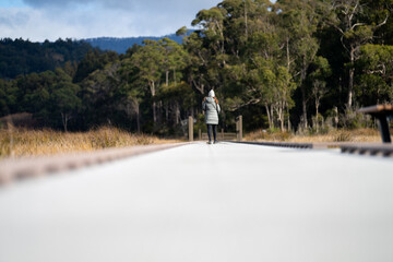Fototapeta na wymiar woman walking on a path and track in tasmania australia