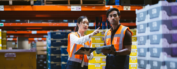 Warehouse worker and manager checks stock and inventory with digital tablet computer in the retail...