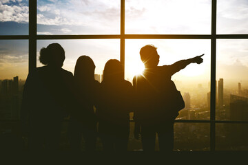 Silhouette of people pointing at something inairport