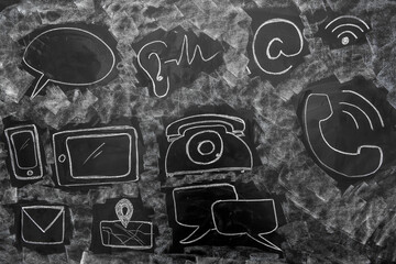 Close up of drawn communication icons on blackboard