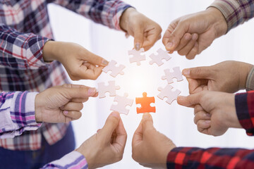 A group of business people assembling jigsaw puzzle. The concept of cooperation, teamwork, help and...