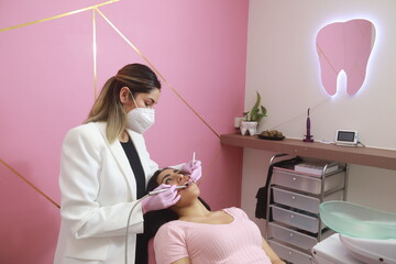 young dental health specialist performs a dental cleaning
