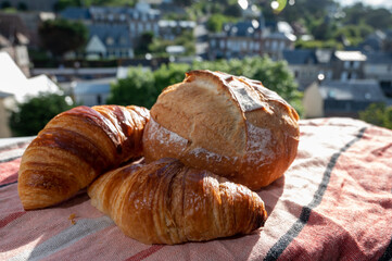 Two fresh baked butter croissants and whitre wheat farmers breasd from French bakery