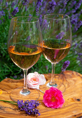French rose wine from Provence, two glasses of wine with purple lavender flowers on background