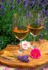 French rose wine from Provence, two glasses of wine with purple lavender flowers on background