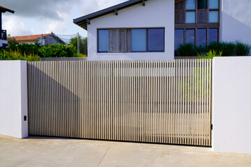 wooden modern gate portal of home door of suburbs wood house in street view